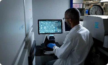 Arvinas scientific staffer reviewing data on monitor screen